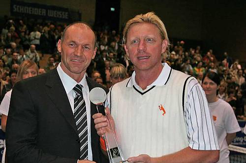 Tennis-Legende Boris Becker hält seine JOSKA Trophäe stolz in den Händen.